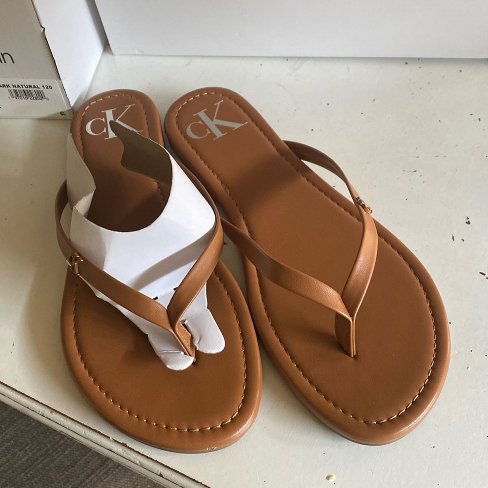 Never worn Calvin Klein caramel brown flip flops.
